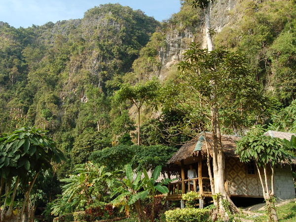Cliffs and jungle loom over our hut