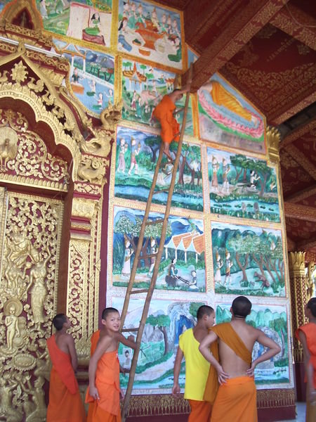 Novice monks climbing a ladder to rescue temple key