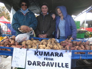 Having fun at the stall selling kumara (sweet potato)