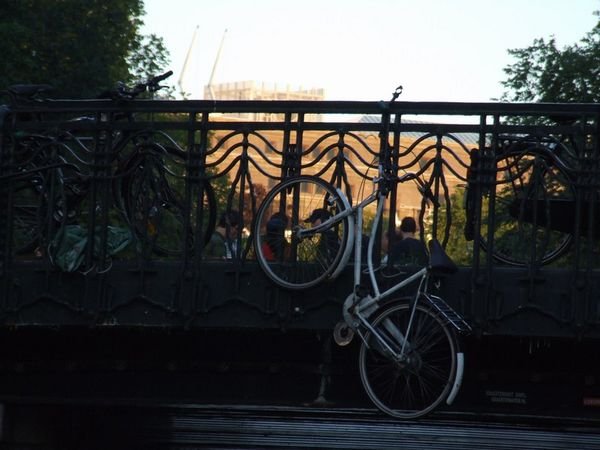 Bicycle hanging from bridge