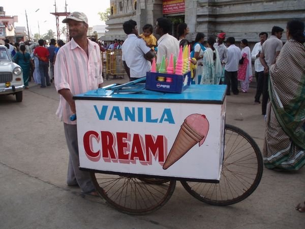 Icecream vendor and a cool Ambassador Classic in the back ground