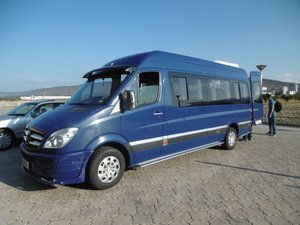 Blue Mercedes Sprinter to the airport.