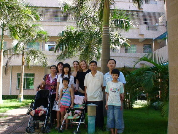 Everyone including Bao Zhu and Mei Li in front of the orphanage