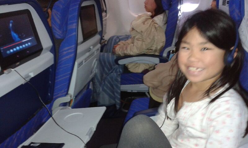 Maya on the plane thrilled to be coming home.
