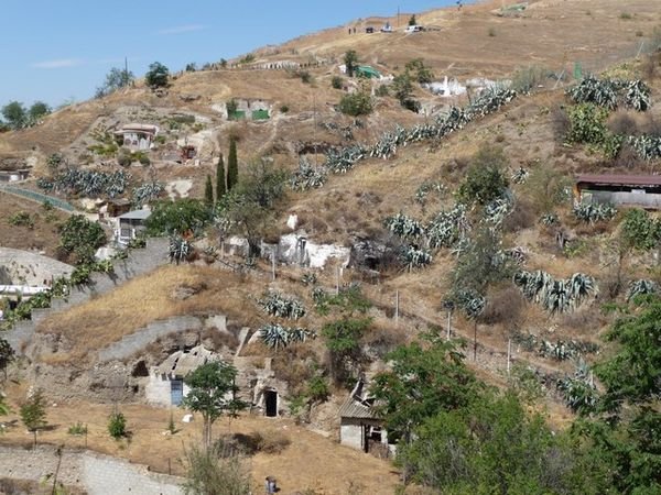 View across the mountain of Sacromonte with scattered cave houses
