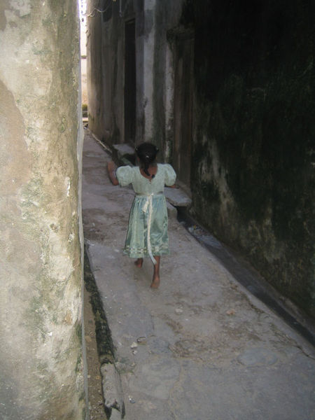 Girl running through streets of Lamu