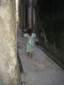 Girl running through streets of Lamu