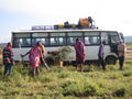 Masai men help a bogged bus on the Mara-Nairobi road