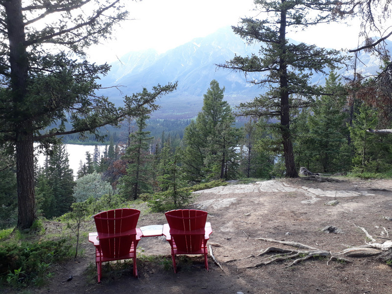 More red chairs with view of Pyramid Mountain