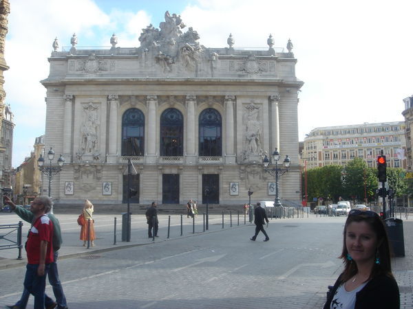 Ange standing in front of the spectacular Opera