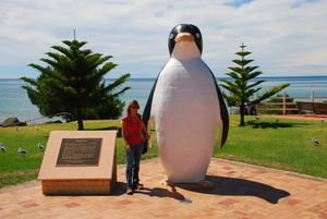 Claire by the Fibro-concrete statue of a penguin at Penguin!