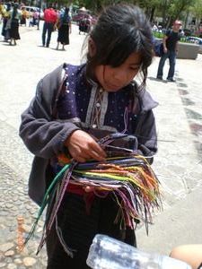 Little Mexican girl selling bracelets