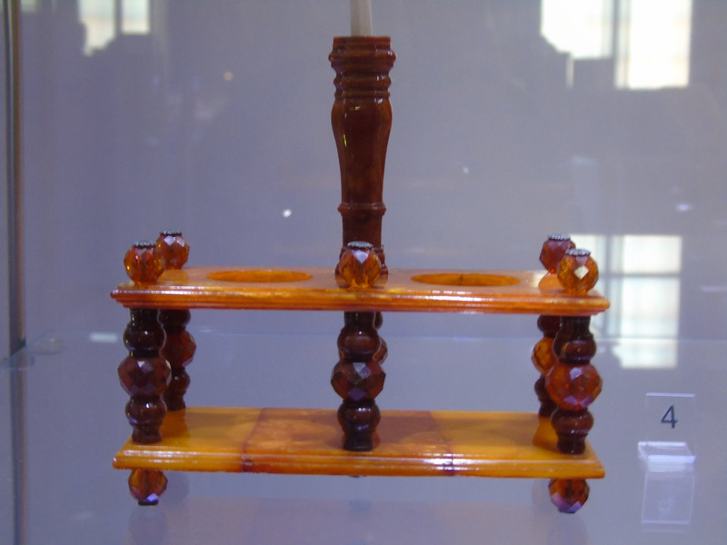 This pen stand is made of amber which is found and worked locally. It was in a museum devoted to the subject