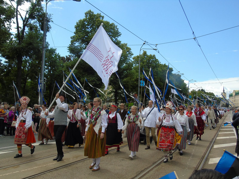 It disappeared into the distance. The marchers carried streamers of the Estonian national colours. The flags and signs indicate where the group comes from