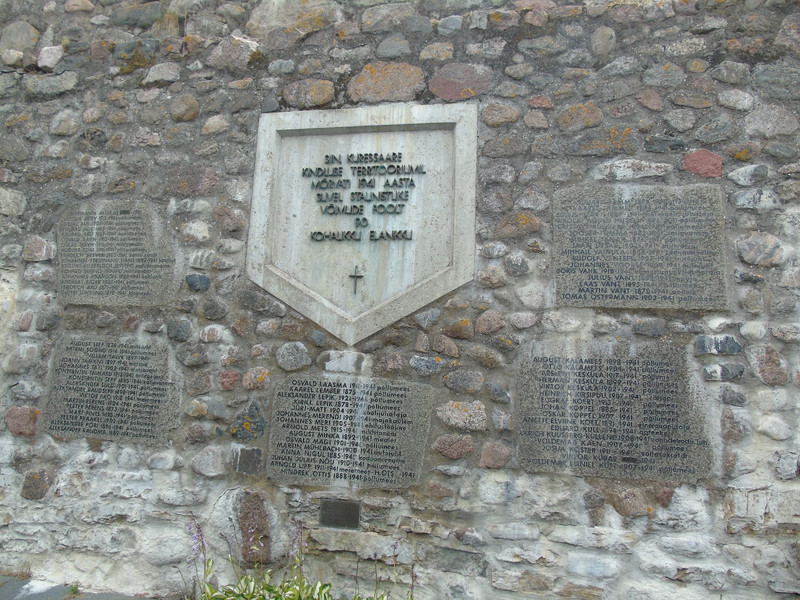 A memorial on the wall to the 90 people killed in the castle grounds by the Red Army in 1941
