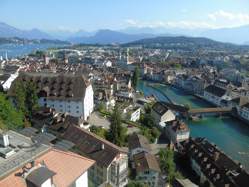 Looking over the city scape with the 15th century timber Spreuer Bridge crossing the River Reuss and Lake Lucerne in the background