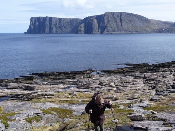 Wendy concentrating over the rocky shoreline. The cliffs in the background are Nordkapp