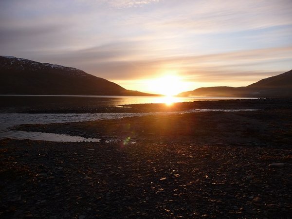 Midnight sun shining down the fiord