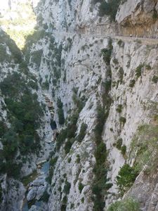 Gorges de Galamus. The road runs along the top of the pictiure with Wendy walking along it.