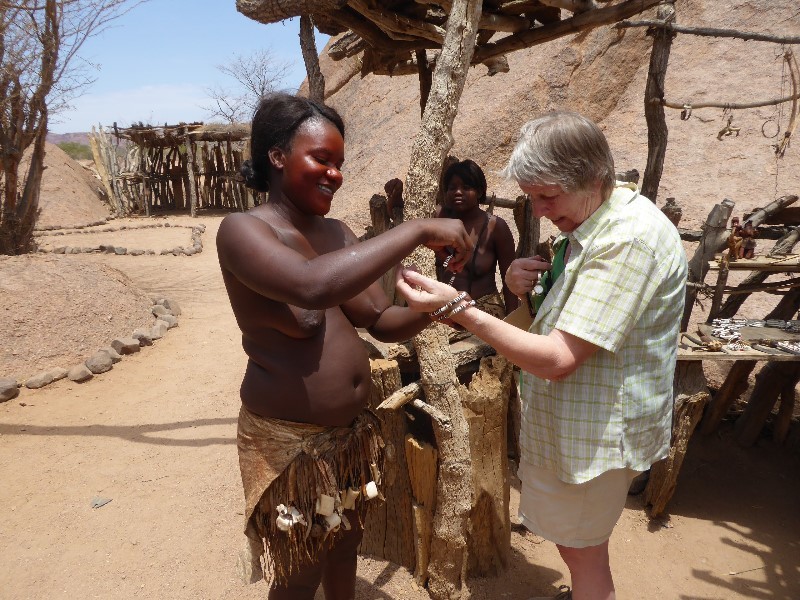 Sharon showing Wendy how to put on a locally made bracelet she had just bought