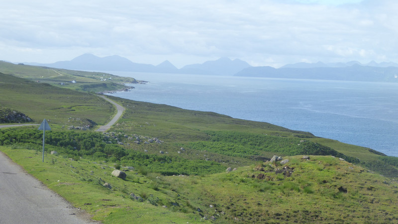 The road around the Applecross peninsular with the Cuillin Hills and other mountains of Skye laid out in the background