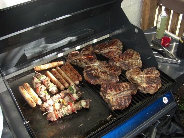 Outrageously big steaks and kangeroo sausages on the Barbie
