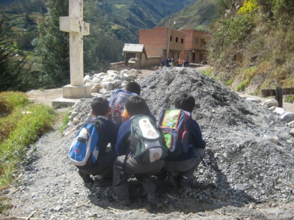 Schoolboys playing hide and seek from the ´chicas´up the road