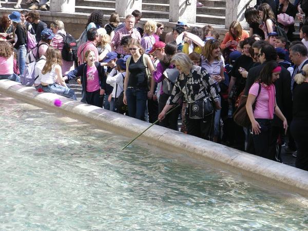 Homeless lady fishing money out of Trevi Fountain