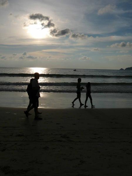 Allan and girls walking along Patong beach