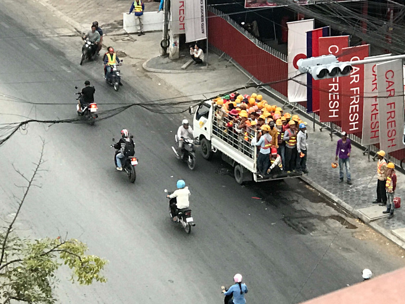Construction workers piling in a truck to go to work