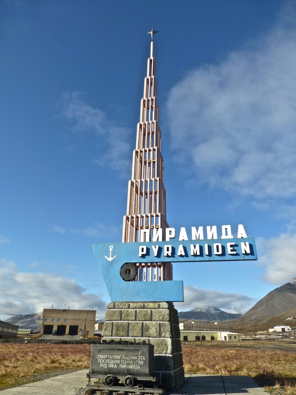 The monument of Pyramiden, with the last ton of coal extracted from the mine behind it