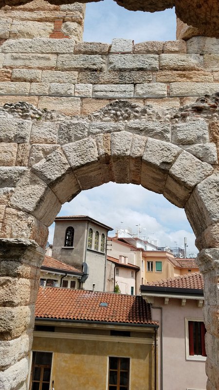Looking through an arch - the town has been built right up to the Arena.