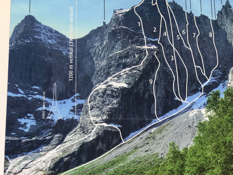 A PHOTO OF THE TROLL WALL WITH THE VARIOUS ROUTES THAT CIMBERS HAVE USED TO ASCEND