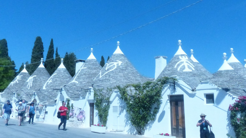 ROW OF TRULLI WITH PAINTED SIGNS ON ROOFS