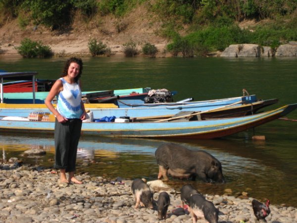 Shell posing with the pigs on the river in Muang Khau