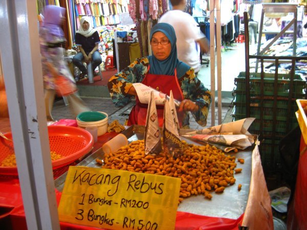 Fried monkey nuts .. woman seller!?