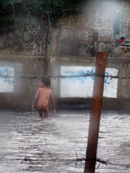 cheeky kid playing in the floods