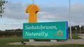 saskatchewan-sign-with-saskatchewan-naturally-slogan-sign-outside-welcome-center-at-the-manitoba-saskatchewan-border-traffic-passing-in-the-background-trans-canada-highway-1-ontario-canada_vbb-i1lix__S0000
