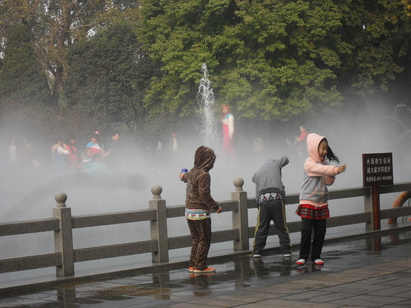 Shrieking children enjoying the mist