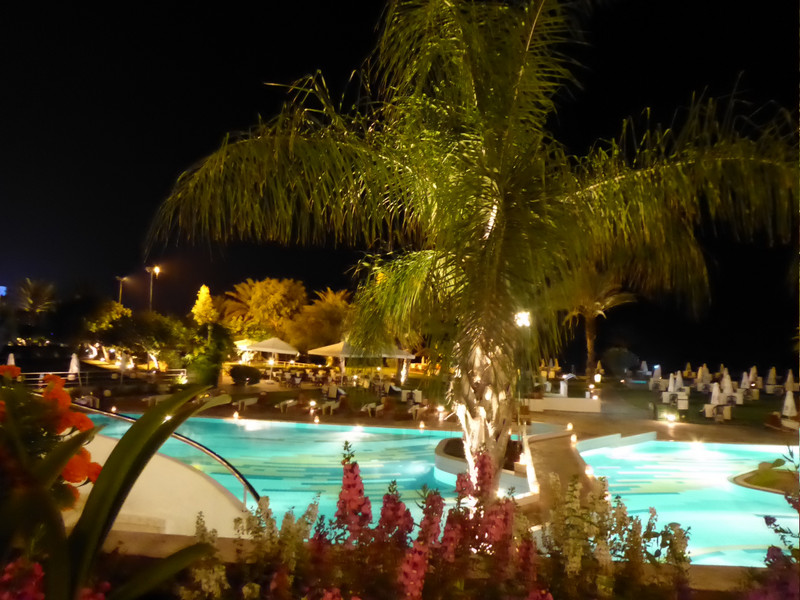 Night time view over swimming pool 