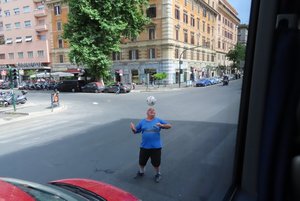 Guy Bouncing Ball In Traffic For Money