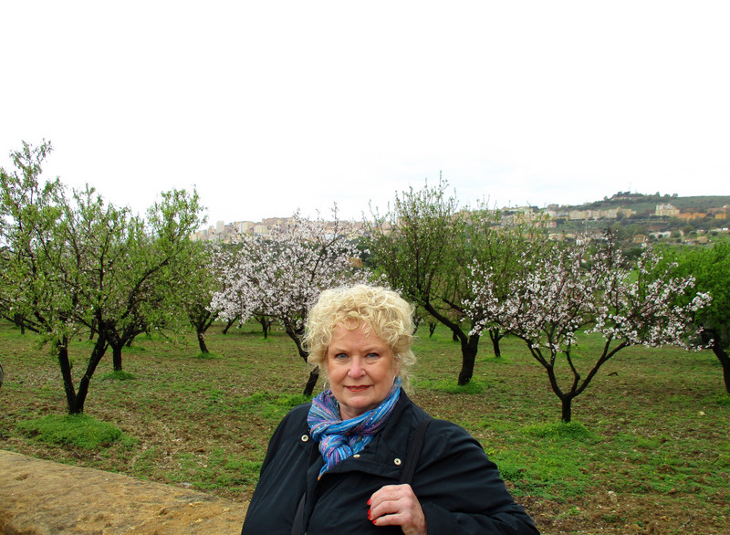 Dee near a grove of almond trees