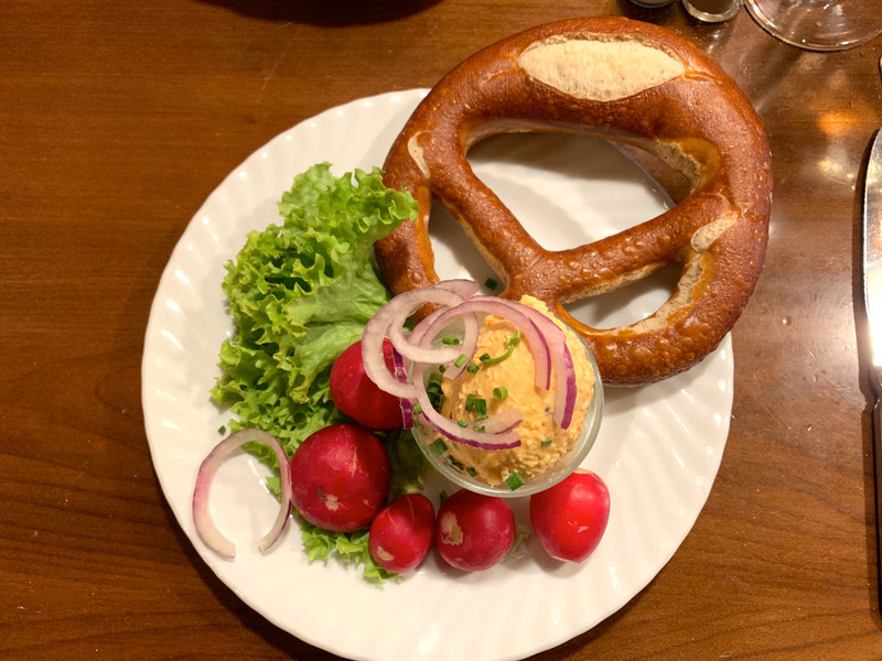 Camembert cheese, radishes and Bavarian pretzel