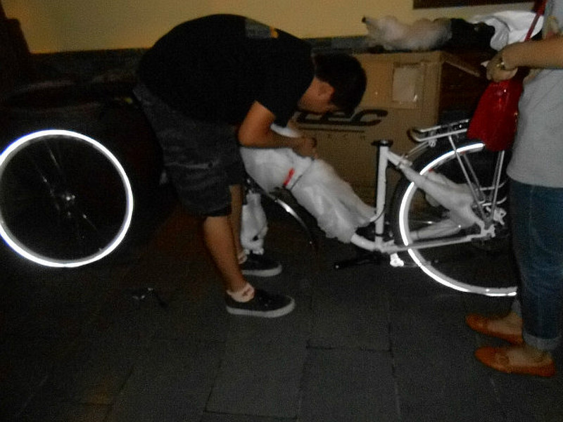 Lui Hui putting bike together 