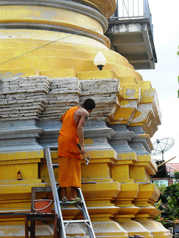 Monk working on stupa