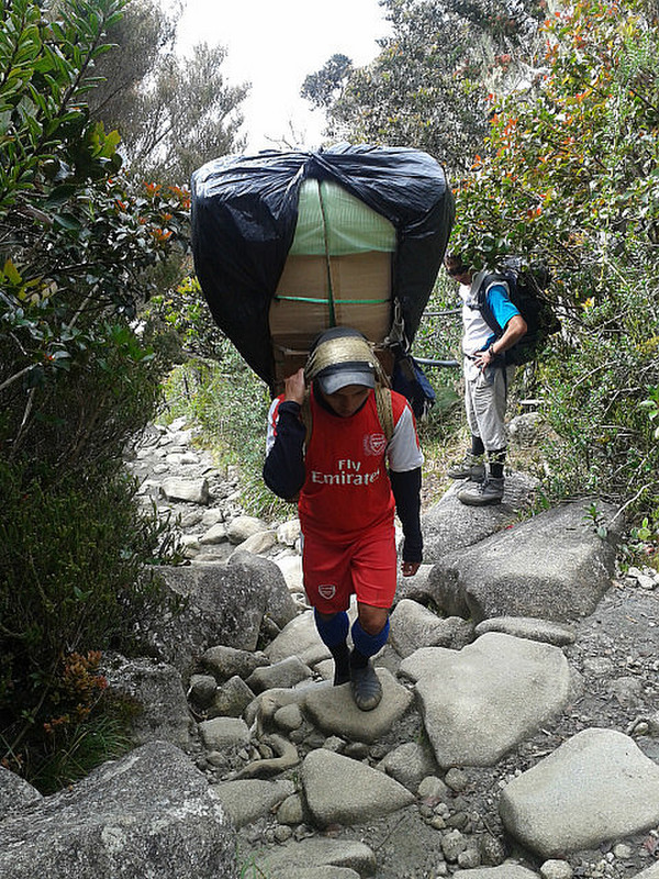 Porters carrying goods up the mountain