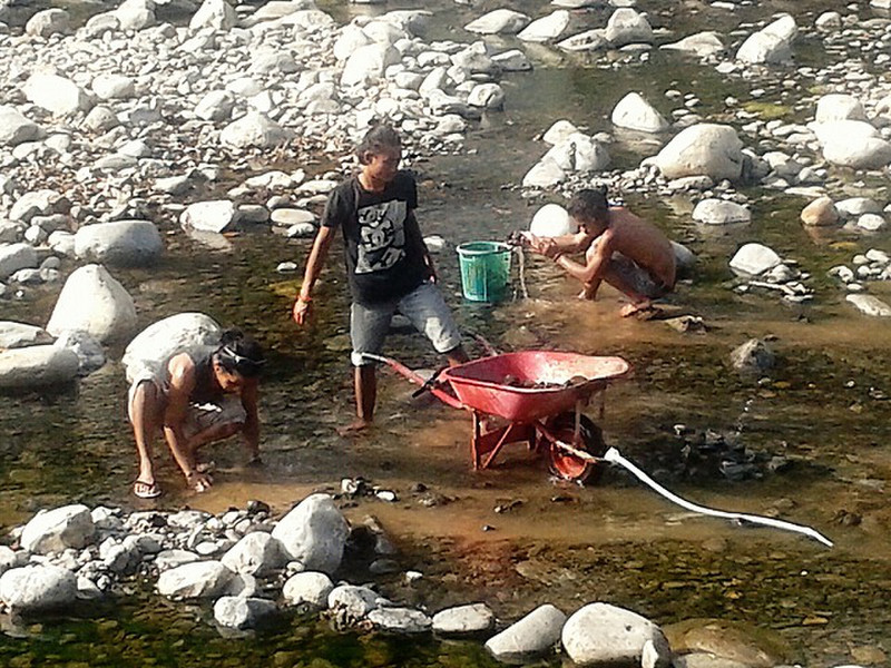Gathering rocks from the low river
