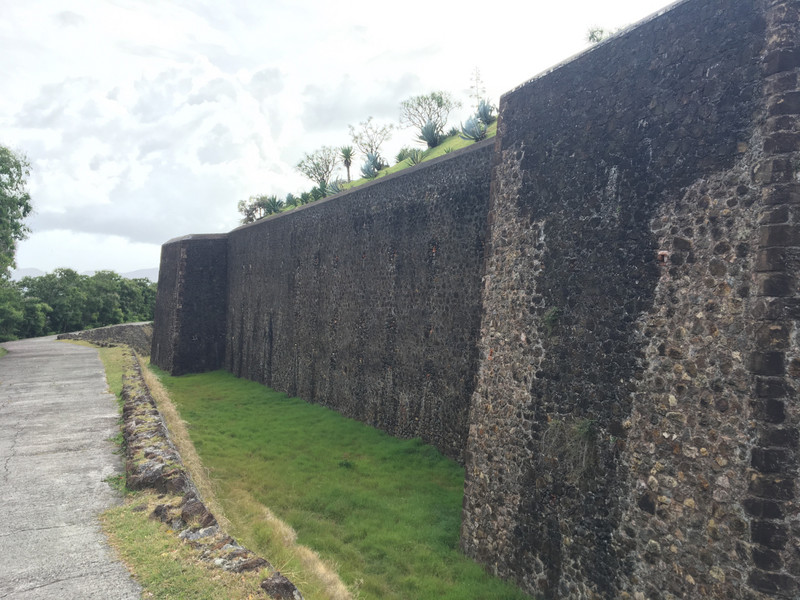 Deep grassy moat around the fort