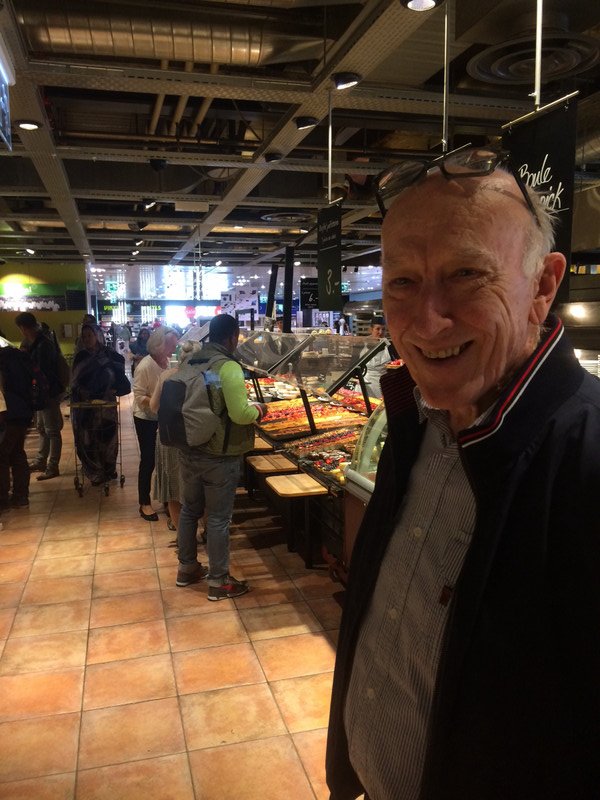 Grandpa in front of the smorgasbord lunch selection on the top floor of Manor