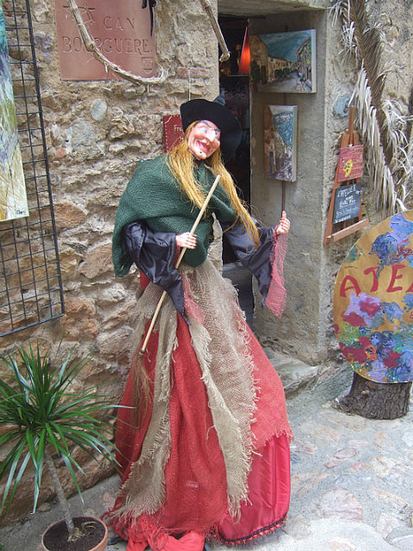Cackling witch outside a shop